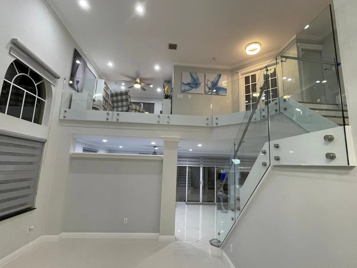 Glass railing staircase top view Miami home
